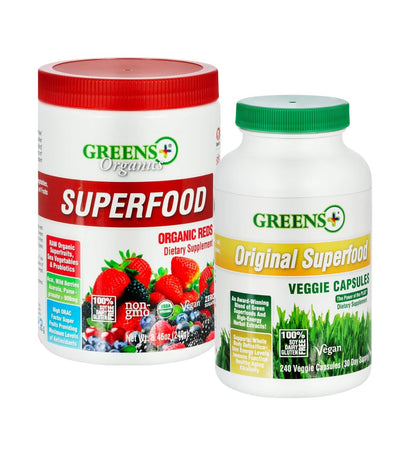 Two bottles of Greens Organics superfood products on a white background